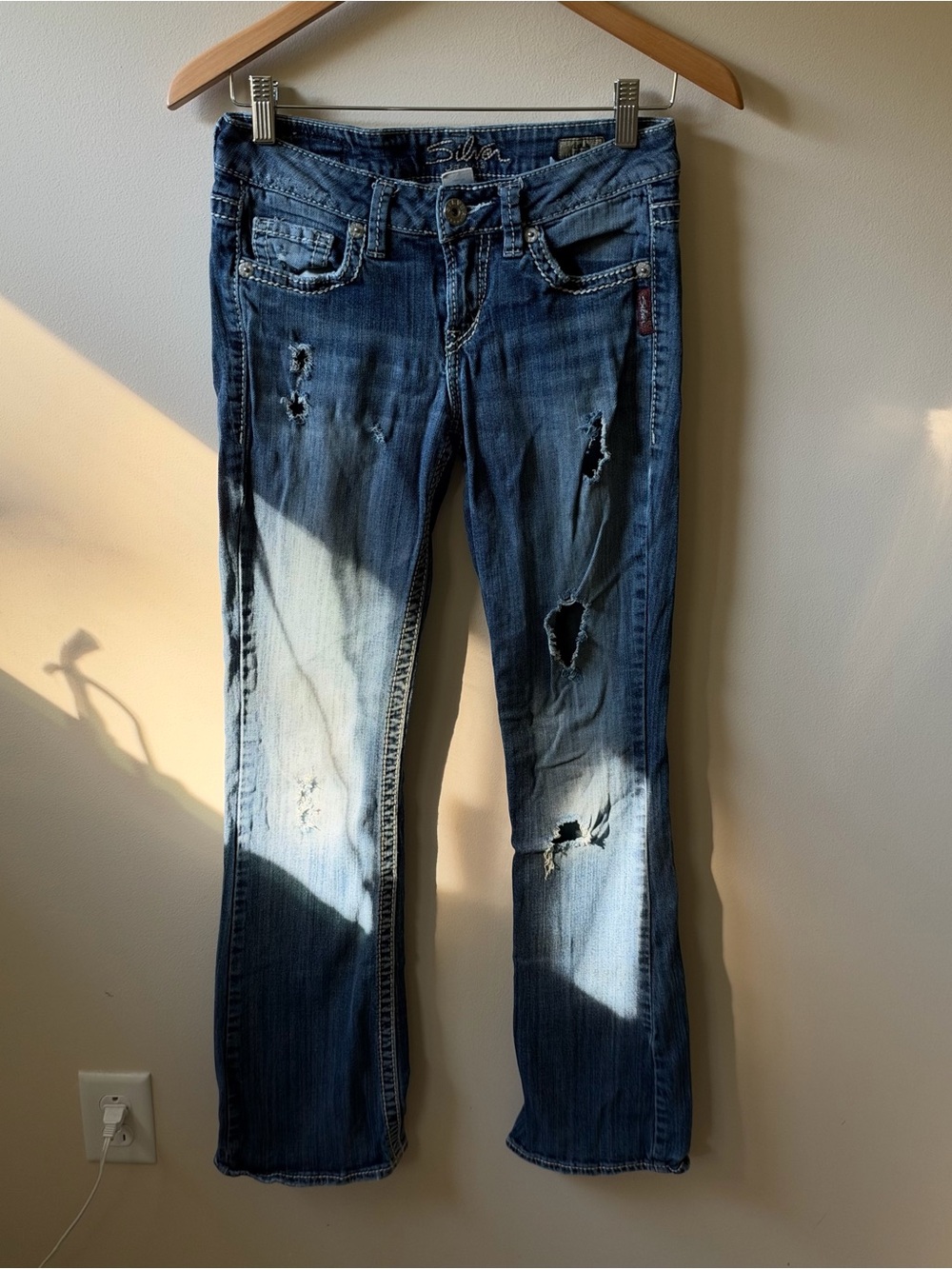 Silver Jeans “Lola Flare” Distressed Low Rise Jeans